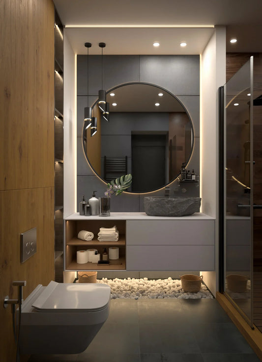 Modern bathroom design with large round mirror, stone sink, wood accents, and under-sink pebble decor