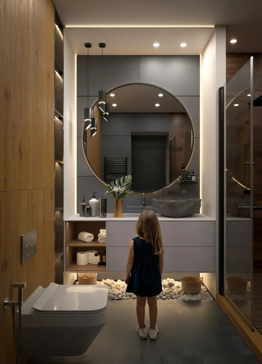 Modern bathroom interior with large round mirror, stone sink, girl standing in front